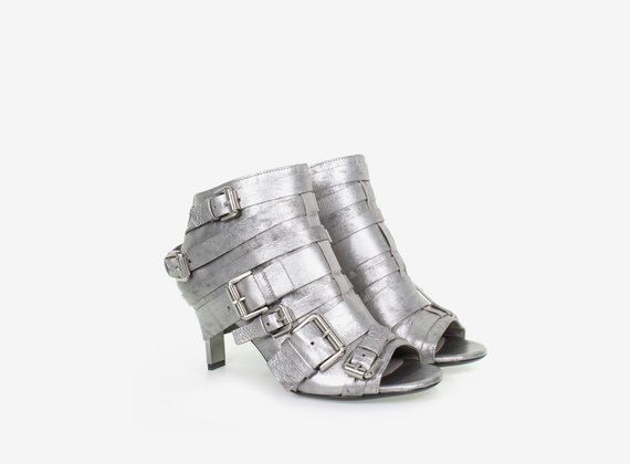 Multi-buckle, open toe ankle boot, crafted from laminate with steel heel