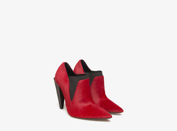 Red pony slippers on pyramid heels