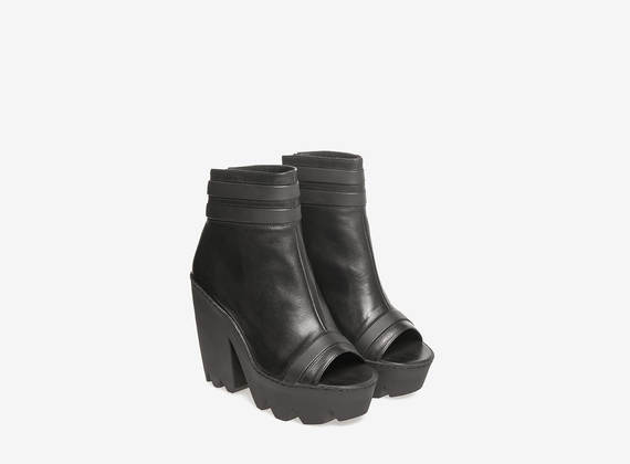 Black leather lug ankle boots
