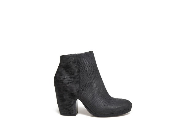 Carved leather ankle boots with shell-shaped heel