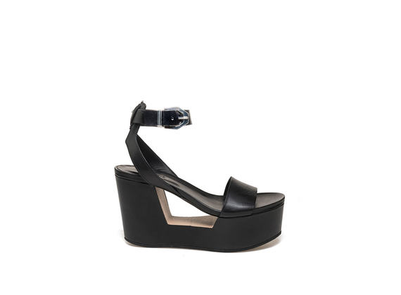 Sandal with buckle on perforated wedge
