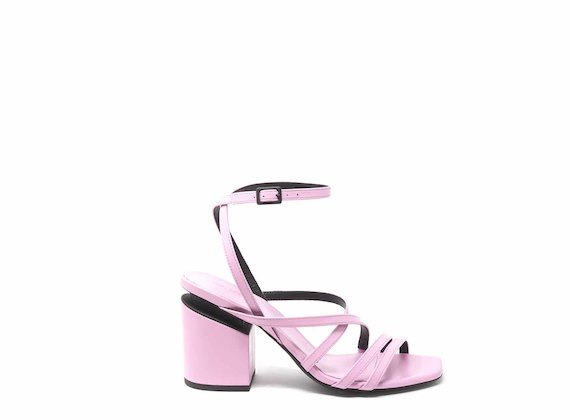 Pink sandals with criss-crossing strips and suspended heels