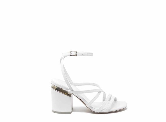 White sandals with criss-crossing strips and suspended heels