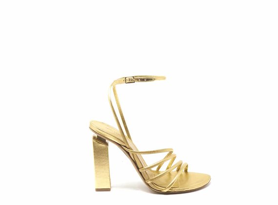 High-heeled sandals with golden strips and ankle strap